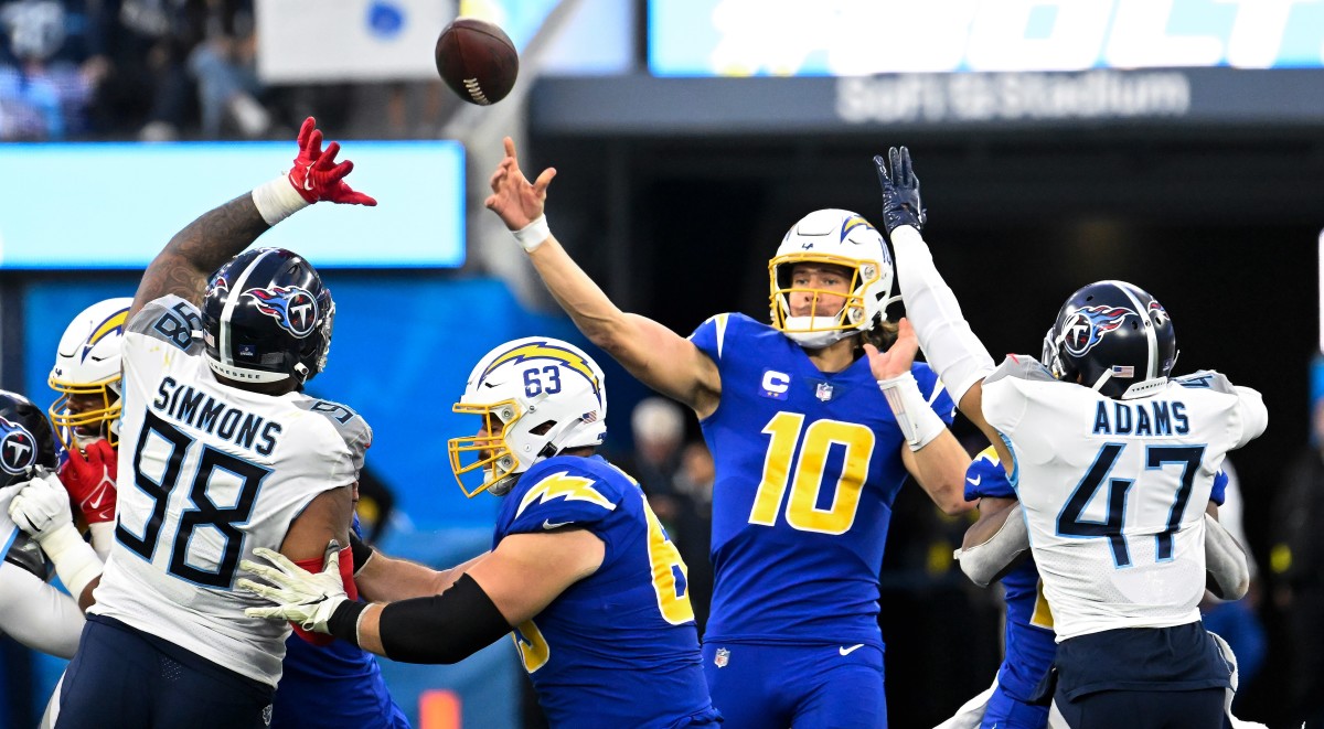 Dec 18, 2022; Inglewood, California, USA; Los Angeles Chargers quarterback Justin Herbert (10) throws a pass over Tennessee Titans defensive tackle Jeffery Simmons (98) in the second quarter at SoFi Stadium. Mandatory Credit: Robert Hanashiro-USA TODAY Sports